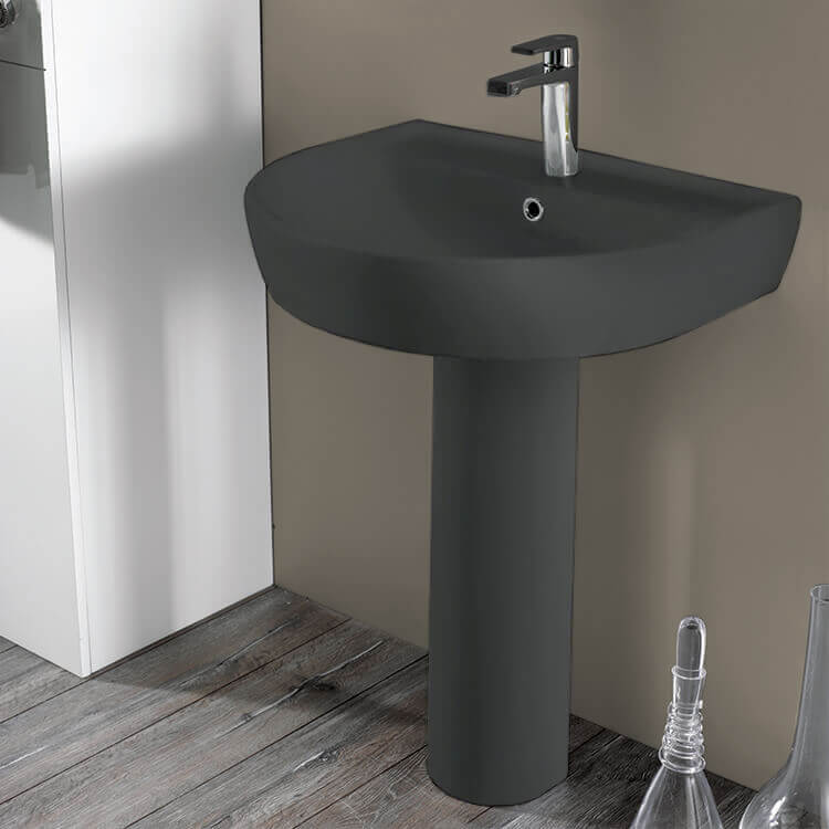 black toilet and pedestal sink
